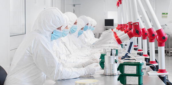 a row of scientists working in a lab